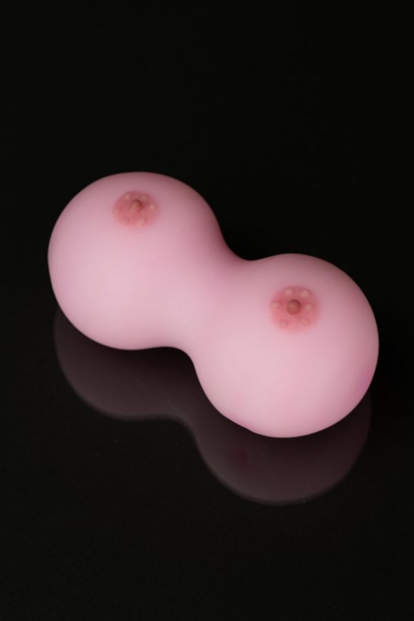 Pink silicone cannabis concentrate container with two circular chambers.