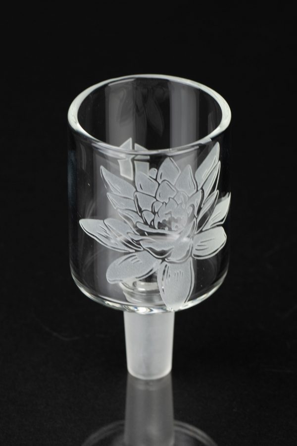 Etched glass cannabis bowl with floral design, studio shot.