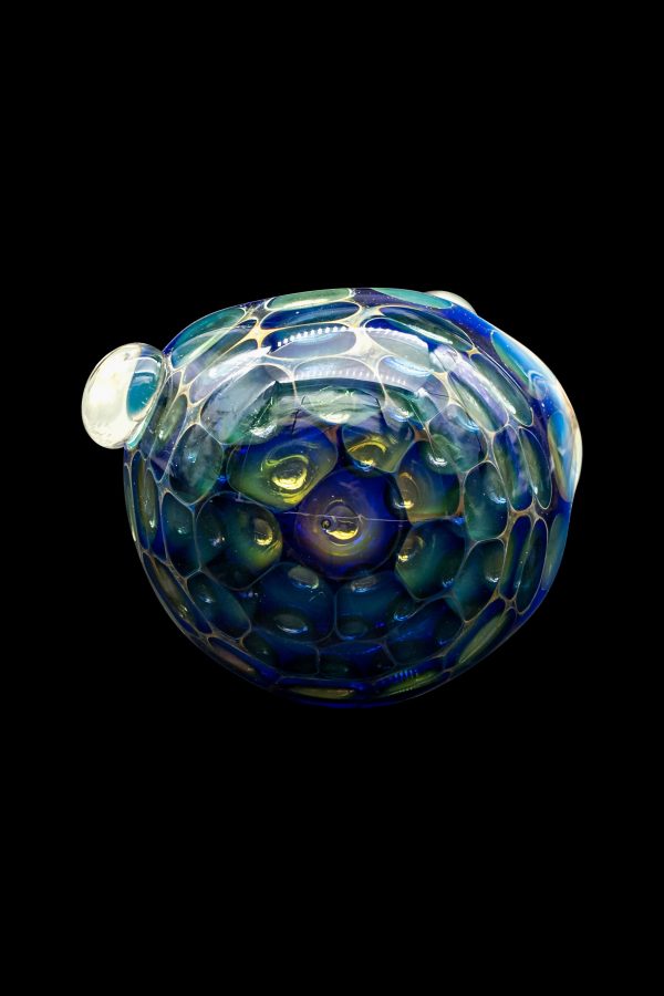 Iridescent glass cannabis water pipe against a black background.