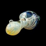 Iridescent glass cannabis pipe against a black background.