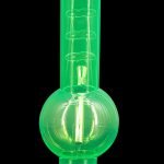 Glowing green glass water pipe (bong) on a black base.