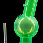 Green glass bubbler with a metal downstem, isolated on a black background.