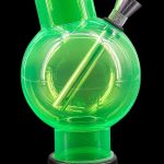 Green glass bubbler water pipe with black base.