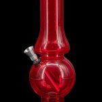 Red glass bubbler water pipe for smoking cannabis.