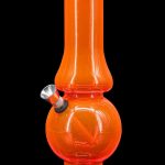 Orange glass water pipe (bong) on a black base.