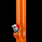 Orange glass water pipe with metal accents against a black background.