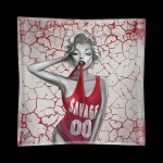 A glass ashtray featuring a stylized black and white illustration of Marilyn Monroe in a red tank top with "SAVAGE" printed on it, set against a cracked red and white background.