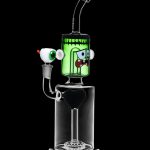 Green glass water pipe shaped like a monster with cartoon eyes, featuring a percolator base and clear mouthpiece.