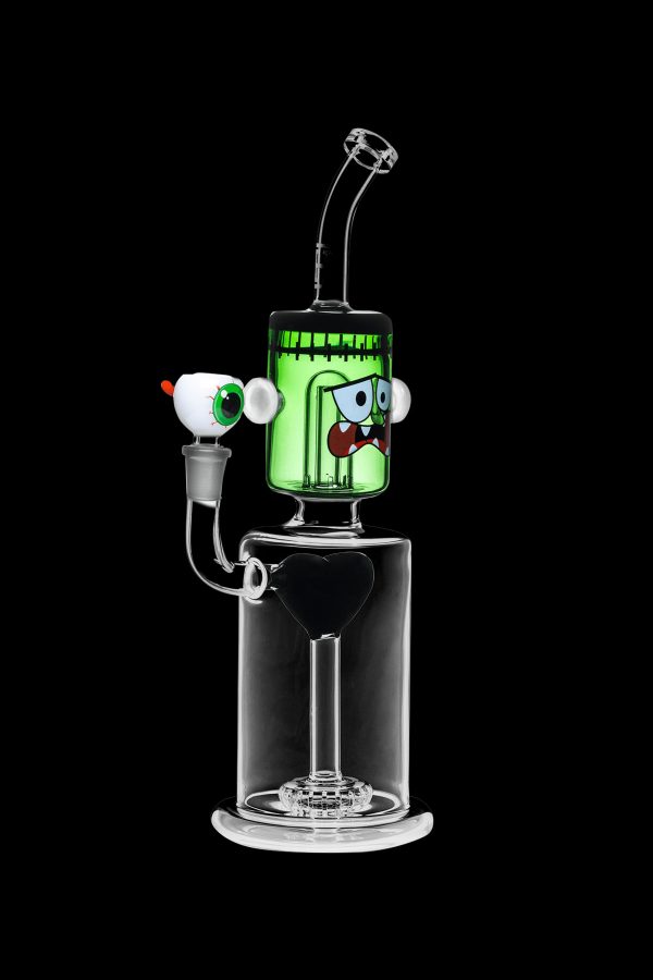 Green glass water pipe shaped like a monster with cartoon eyes, featuring a percolator base and clear mouthpiece.