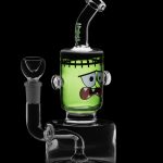 Green glass water pipe shaped like Frankenstein's monster with a clear glass bowl.