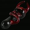 A side view of the Devil Horns and Tail Fritted Spoon Pipe, showcasing its detailed glasswork and unique sculpted design.