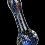 A close-up, angled view of the Dichro Dream Spoon Pipe, showcasing its dichroic glass with a shimmering, colorful effect.