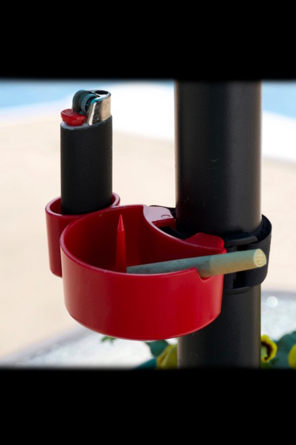 Red ashtray and lighter holder clipped to a black pole, likely for cannabis use.
