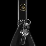 Clear glass beaker bong with all-seeing eye logo.
