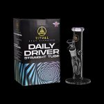 Product shot of a “Daily Driver” glass tube and stand, packaged in a black box with colorful geometric design.
