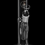 Clear glass water pipe (bong) with intricate detailing and a black accent piece, isolated on a black background.