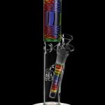 A vibrant glass bong with colorful geometric patterns and a clear base, isolated on a black background.