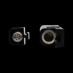 Close-up of two cannabis oil vape cartridge components against a black background.