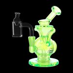 A glowing yellow glass dab rig with a quartz banger, positioned on a dark background.