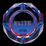 Blue glass ashtray with gold “Elite” lettering and cannabis leaf detail.