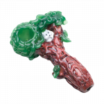 The Empire Glassworks "Squirrels Nest" Spoon Pipe is shown in a close-up, angled view, featuring a textured, green and brown design resembling a nest.