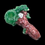 A three-quarter view of the Empire Glassworks "Squirrels Nest" spoon pipe, featuring a sculpted green and clear glass bowl.