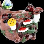 The Empire Glassworks Spoon Pipe - Nature features a sculpted, colorful glass bowl resembling mushrooms and foliage, viewed from a slight angle.