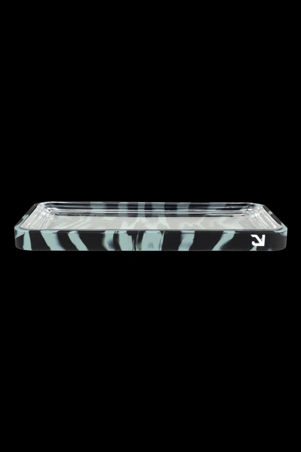 Clear glass rolling tray with white marbling against a black background.