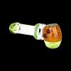 Green and orange glass pipe isolated on a black background.