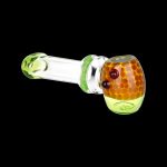 Green and orange glass pipe isolated on a black background.