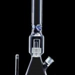 Clear glass bong with ice catcher and diffuser downstem, accompanied by a separate glass bowl and downstem, against a black background.