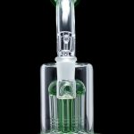 Green glass bubbler with multiple diffusion stems, isolated on a black background.