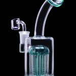 A glass water pipe, also known as a rig or bong, with a turquoise-colored percolator and curved mouthpiece, isolated on a black background.
