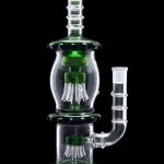Green glass water pipe (rig) with percolators, isolated on black.