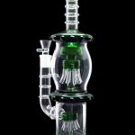 A vibrant green and clear glass water pipe (bong) with a complex multi-chamber percolator design.