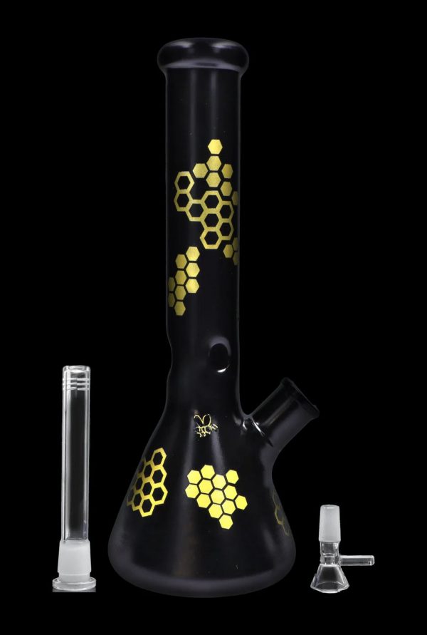 Black glass bong with gold honeycomb pattern, accompanied by a downstem and bowl.