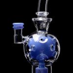 Blue glass water pipe (bong) with bubbler and intricate design, isolated on a black background.