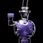 Purple glass water pipe (bong) with bubbler and intricate design.