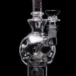 Clear glass water pipe (rig) with intricate bubble detailing, featuring a glass bowl and downstem.