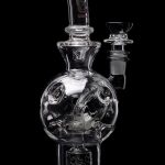 Clear glass water pipe with intricate bubble perc filtration system.