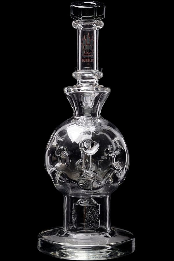 Clear glass water pipe with sculpted skull inside spherical chamber, studio shot.