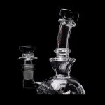 Clear glass water pipe (rig) with intricate design, isolated on a black background.