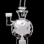 Clear glass water pipe shaped like a skull with a rounded base, isolated on a black background.