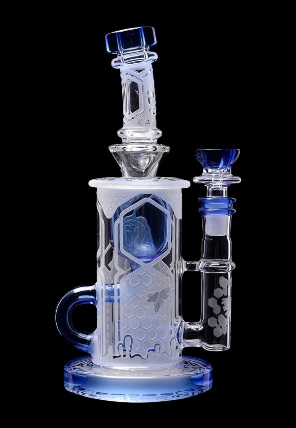 A detailed glass water pipe (bong) with a honeycomb pattern and blue accents, isolated on a black background.