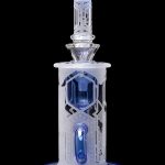 Intricate glass dab rig with blue accents, featuring a geometric, lattice-like design.