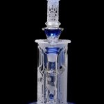 Blue and clear glass water pipe (rig) with intricate patterns, isolated on a black background.