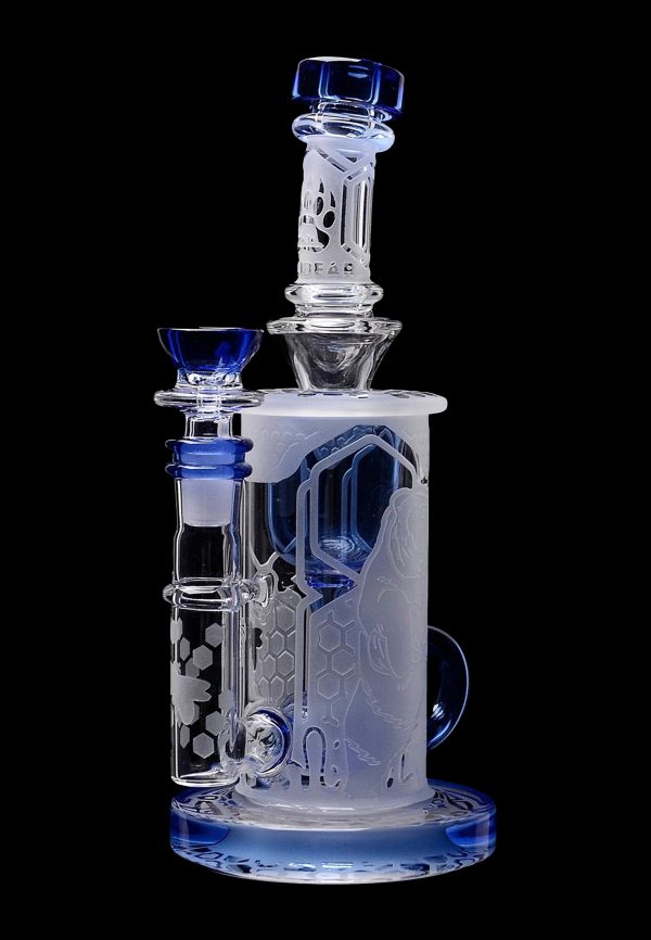 Blue and clear glass water pipe (bong) with intricate etched designs.