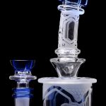 Blue and clear glass dab rig with intricate designs, including a separate bowl piece.