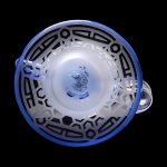 Blue glass bubbler with geometric patterns, viewed from above.