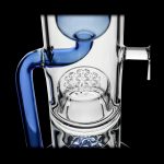 Blue and clear glass dab rig with intricate honeycomb perc diffusion.